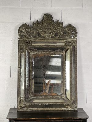Large empire style repoussé metal mirror